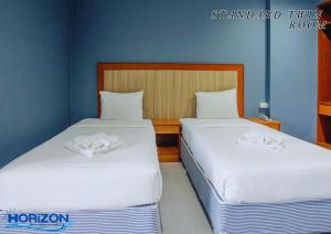 Postel nebo postele na pokoji v ubytování Horizon Hotel
