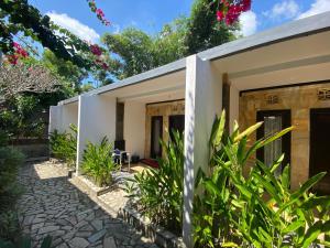 a home with a garden and plants at Ashana Hotel in Uluwatu