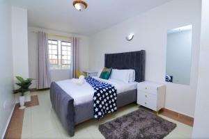 a bedroom with two beds and a window at Garden estate 1 bedroom furnished apartment in Nairobi