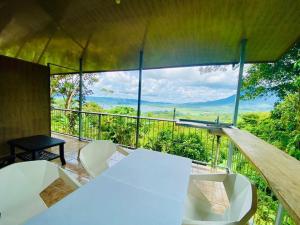 a room with a table and chairs on a balcony at Arenal Jungla Lodge in San Ramón +6 photos