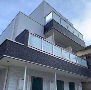 a large house with a balcony on top of it at Glanz Okubo 101 in Tokyo