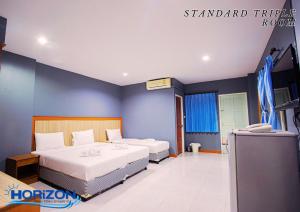 Postel nebo postele na pokoji v ubytování Horizon Hotel