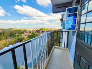a balcony with a view of a city at Garden estate 1 bedroom furnished apartment in Nairobi