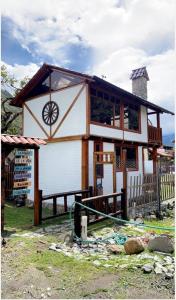 a house with a wheel on the front of it at Tiny Celina House in Baños