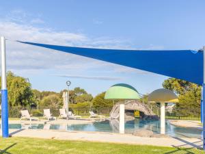 a blue and green canopy over a swimming pool at NRMA Warrnambool Riverside Holiday Park in Warrnambool