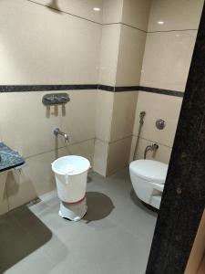 a bathroom with a toilet and a bidet at HOTEL SAHYOG & ROOMS in Surat +21 photos