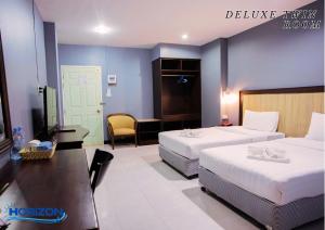 Postel nebo postele na pokoji v ubytování Horizon Hotel