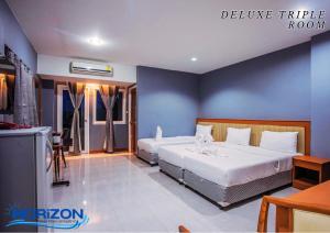 Postel nebo postele na pokoji v ubytování Horizon Hotel