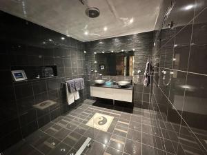 a bathroom with a shower and a sink and a toilet at Cozy Cave Coober Pedy in Coober Pedy