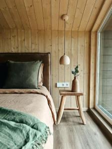 a bedroom with a bed and a table and a window at Bird nest in Undva