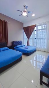 a bedroom with two beds and a ceiling fan at YS Atlantis Residences Melaka - Pool View in Melaka