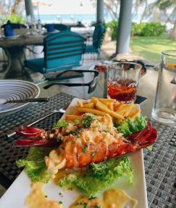 a plate of food with shrimp and french fries on a table at Elysium in Unawatuna
