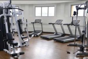 a gym with several tread machines in a room at Two Bedrooms with free wifi, netflix,youtube in Manila