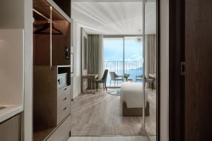 a room with a kitchen with a view of a table at Capital Beachfront Nha Trang in Nha Trang