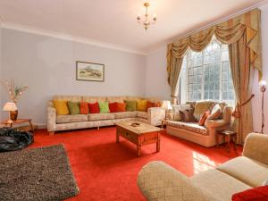 a living room with two couches and a table at Southrepps Lodge in Norwich