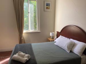 a bedroom with a bed with a towel on it at Royal Hotel - Accommodation only in Parkes