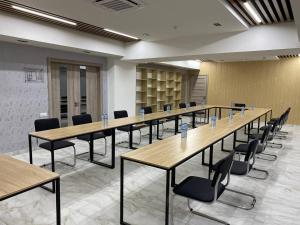 a large room with long tables and chairs at Modern Hotel in Tashkent