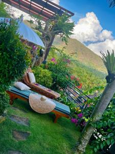 a bench sitting on the grass in a garden at Maya Villa in Candidasa