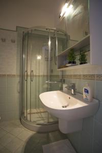 a bathroom with a glass shower and a sink at B&B Celestina Ischia in Ischia +73 photos