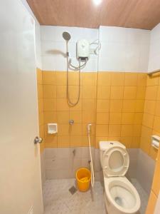 a bathroom with a shower with a toilet and a bucket at Casa Marie Hotel in Daet