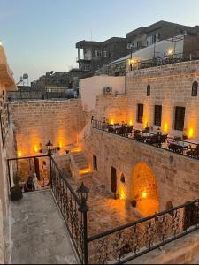 a view of a building with tables and chairs at AĞA KONAĞI HOTEL in Mardin