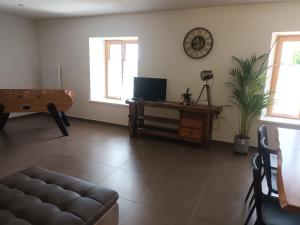 a living room with a couch and a table at gîte proche des cascades du Hérisson 6 personnes in Doucier +19 photos