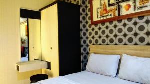 Cama o camas de una habitación en Pelangi Rooms