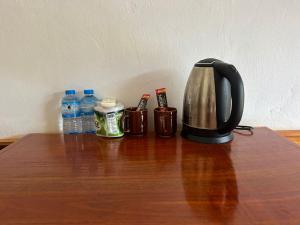a tea kettle and two bottles of water on a table at Nongkhaiw river view in Nongkhiaw