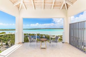 a view of the ocean from the balcony of a house at NEW Tropical Waterfront Cooper Jack Bay Villas in Five Cays Settlement