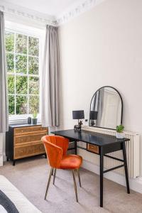 a desk with a mirror and a chair in a room at BRAND NEW LISTING Beautiful 2 bedroom apartment in Bath