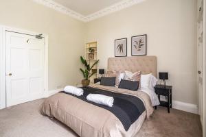 a bedroom with a large bed with pillows on it at BRAND NEW LISTING Beautiful 2 bedroom apartment in Bath