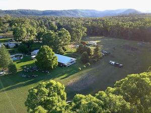 an aerial view of a park with a building and trees at Warrumbungles Mountain Motel in Coonabarabran