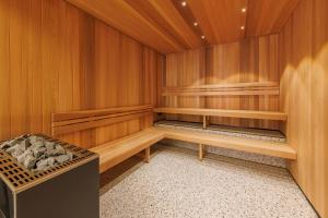 a sauna with wooden walls and wooden shelves at Meriton Suites King Street Melbourne in Melbourne
