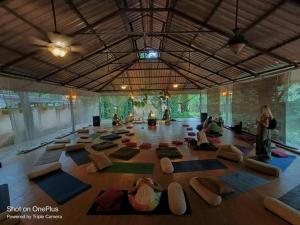 a large room with people doing yoga in a yoga class at Villas in Wellness Centre with Sauna in Arambol