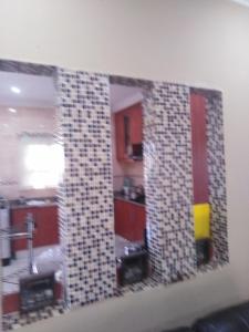 a mirror hanging on a wall in a kitchen at VIP Deluxe Restroom Zone in Durban