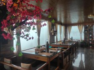 a kitchen with sinks and a bunch of flowers at Hotel Amala in Tawang