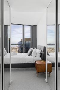 1 dormitorio con 1 cama grande y ventanas grandes de cristal en Sub Penthouse Southbank Apartment - 3BR, en Melbourne