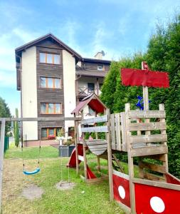 un parque infantil en el patio de una casa en Old Tree Village & Restaurant, en Oświęcim