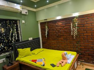 a child laying on a bed in a room at Budget-Friendly Luxury Air-Conditioned Deluxe Suite at Pravuprasad Homestay in Bhubaneshwar