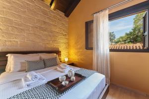 a bedroom with a bed with a tray on it at Sunaktis luxury villa in Chania