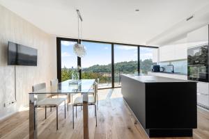 a kitchen with a dining table and a large window at Luxury Penthouse Prague in Prague