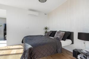 a bedroom with a bed and a couch at Luxury Penthouse Prague in Prague +20 photos