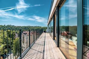 a balcony with glass doors and a view of the city at Luxury Penthouse Prague in Prague