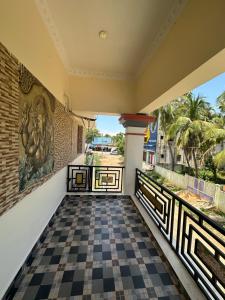a view from the balcony of a house with a checkered floor at Jothi Cottage -HomeStay 
