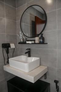 a bathroom with a white sink and a mirror at Bassa nova villa in Panglao