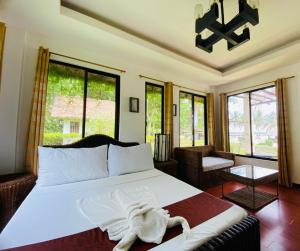 a bedroom with a bed with a robe on it at CATANAUAN COVE White Sand Beach Resort in Catanauan