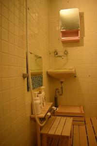 a small bathroom with a sink and a mirror at cheaper for 6th & 7th guest 市街地中心部 一棟貸しの宿 GUEST HOUSE DON'S HOME in Takayama