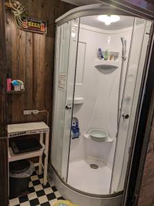 a shower in a bathroom with a checkered floor at 民泊カフェ Gootarian in Kumamoto +35 photos