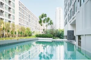 a swimming pool in the middle of a building at Sathon-Charoen Nakhon Condo in Bangkok