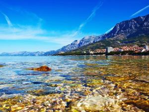 a view of a body of water with mountains at San Apartment in Makarska